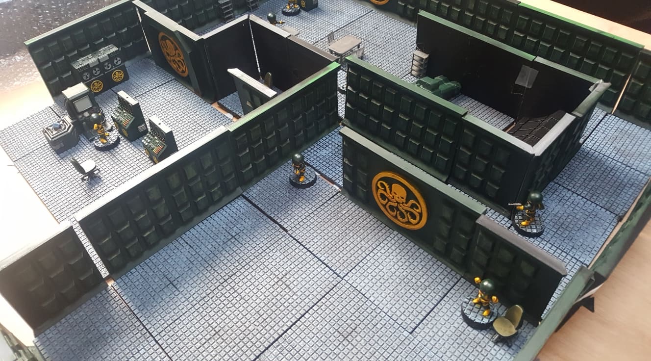 Miniatures moving through a large fortified tabletop complex