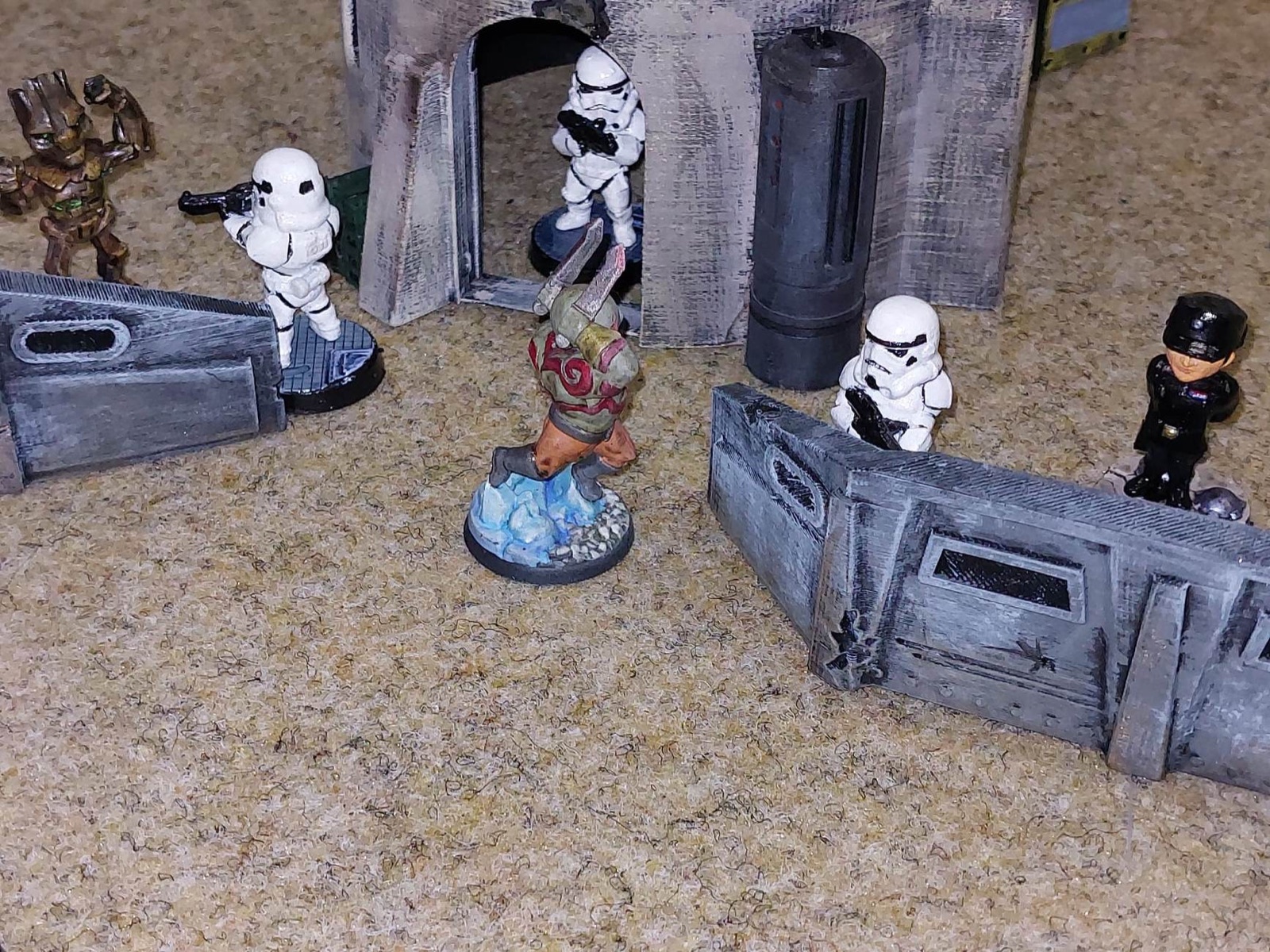 Painted miniatures assaulting a science-fiction tabletop outpost