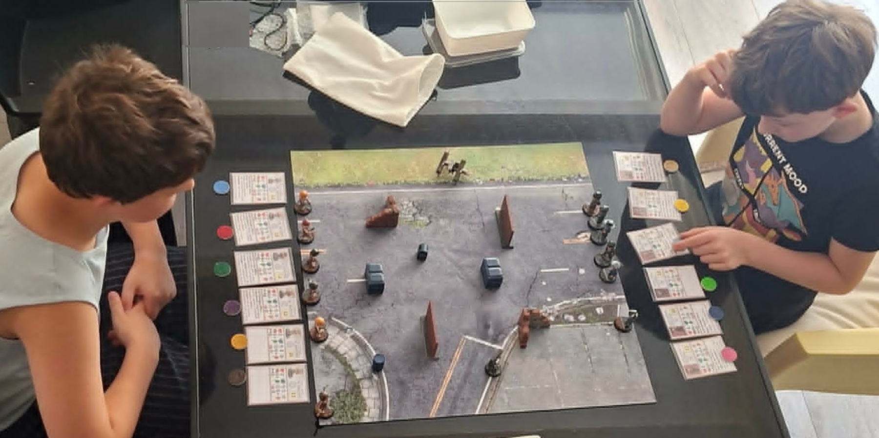 Two young players playing TAP! at a table